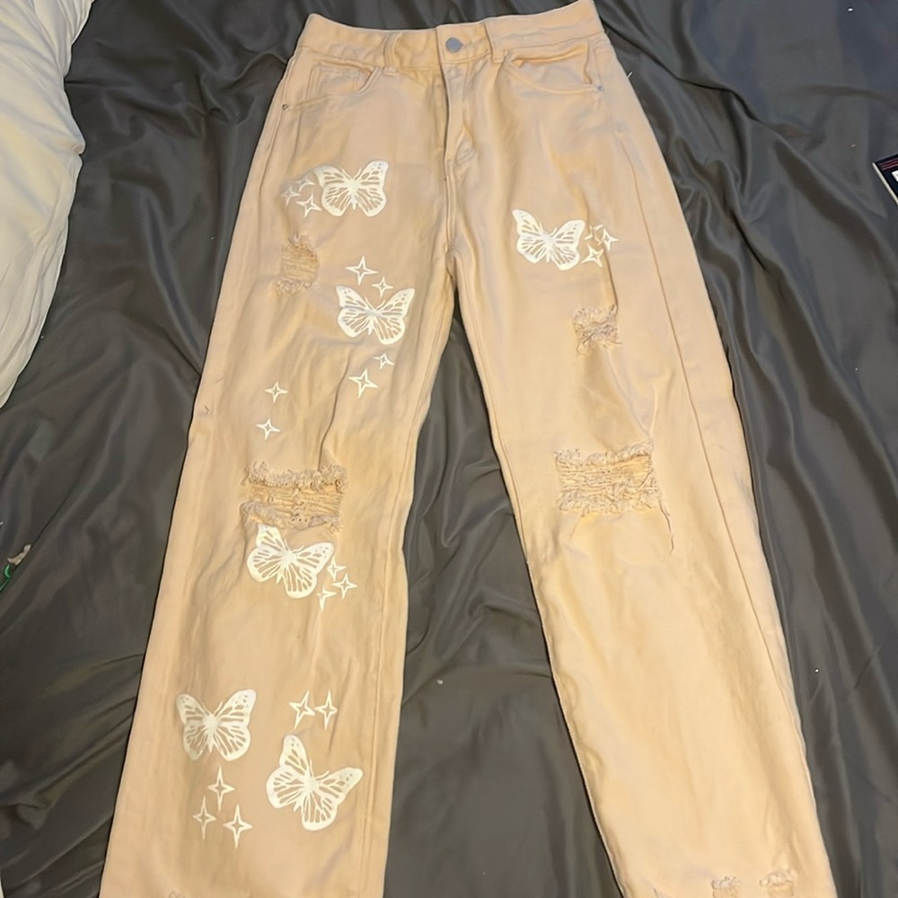 Cream colored butterfly jeans